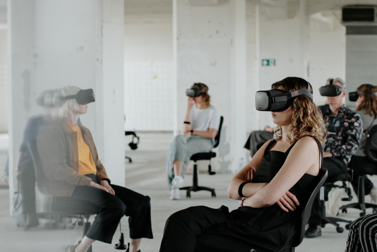Bild der Performance Ascension. Menschen mit VR-Brillen in einem grossen weissen Raum
